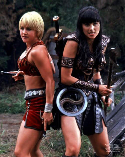 Gabrielle and Xena stand back to back.