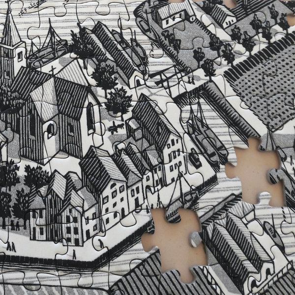 A black and white puzzle depicting a village, two pieces are missing
