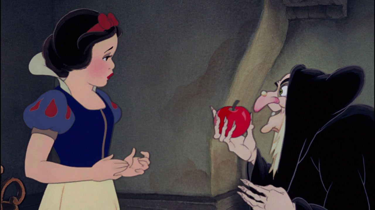 Snow White is offered an apple by the evil witch.